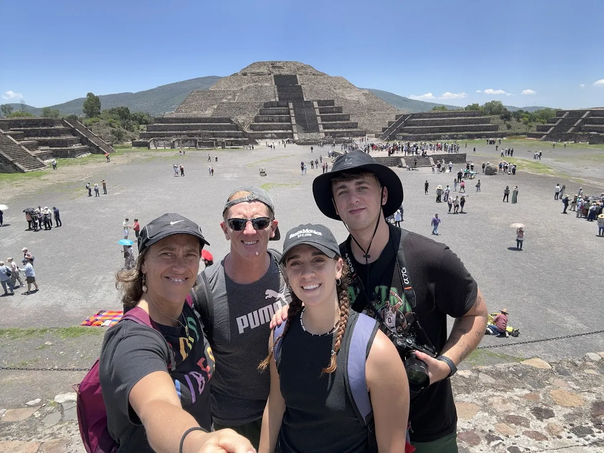 La familia selfie en lo alto de Teotihuacán con la Pirámide de la Luna al fondo